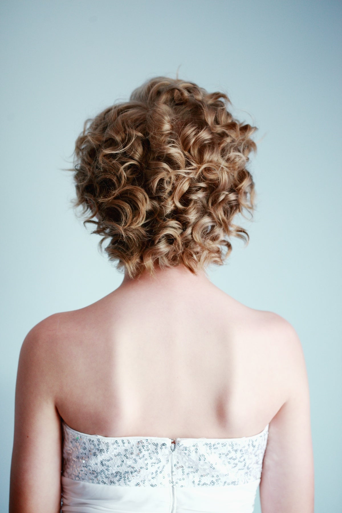 woman wearing white strapless top Image
