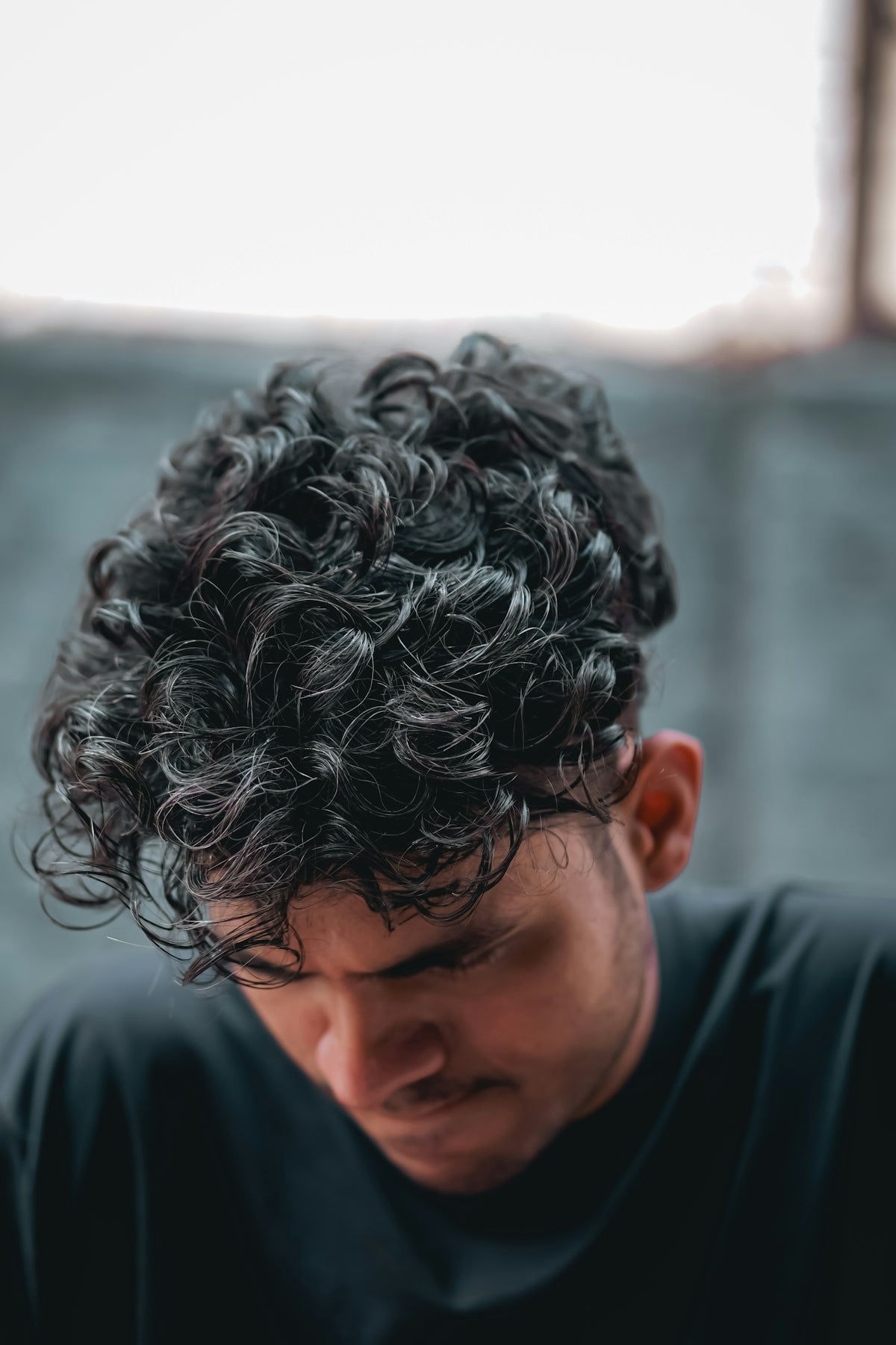a close up of a person with curly hair Image