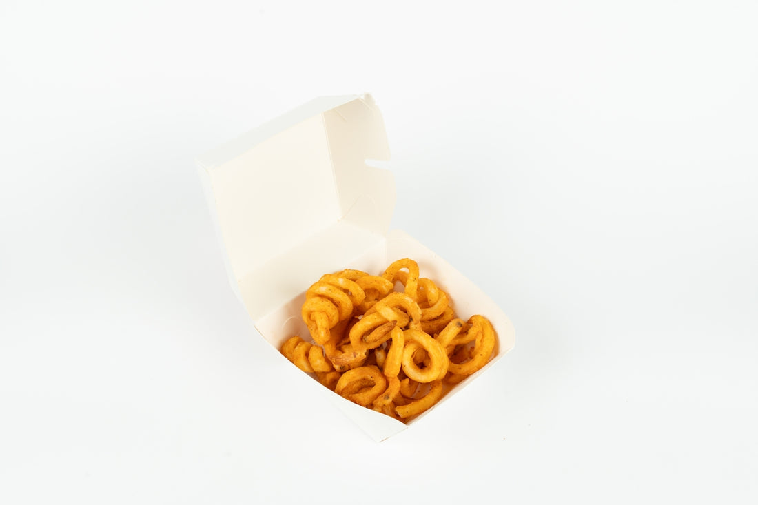 Curly fries in a white takeout box